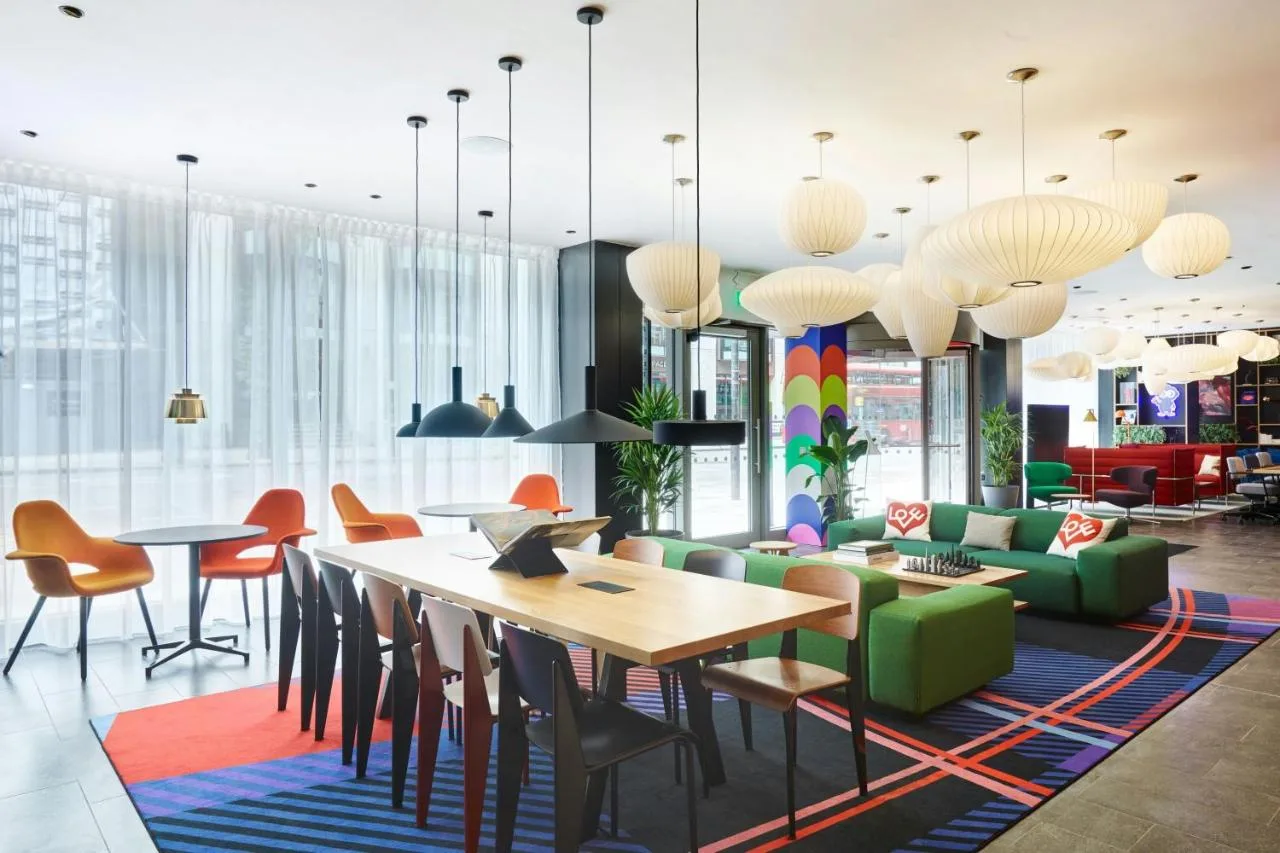 a dining room with a table and chairs at citizenM London Victoria Station in London